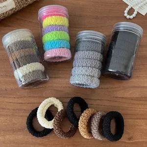 Detailed view of thick high elastic hair ties in transparent storage jars, multi-color set.