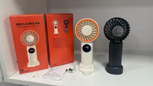 Detailed view of portable handheld LED digital display fan with multiple speed settings.