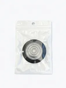 Detail view of MagSafe magnetic phone holder in sealed transparent ziplock packaging bag.