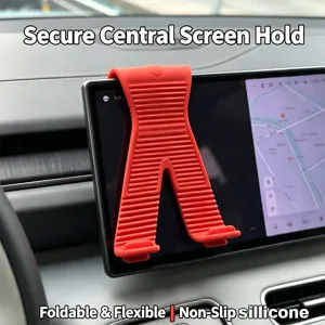 Flexible silicone car phone holder, foldable X-shape mount for central dashboard screen.