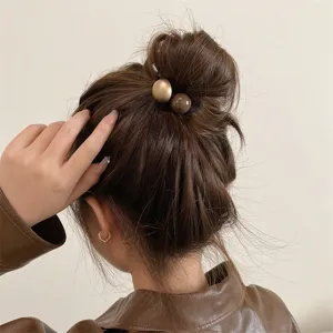 Minimalist retro hair tie with cute ball pendants, perfect chic accessory for elegant buns and ponytails.