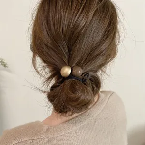 Minimalist hair tie with double balls for low ponytail and bun styling, elegant hair accessory.