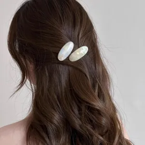 Acetate oval hair clip for women, elegant side barrette with pearl shell texture design.