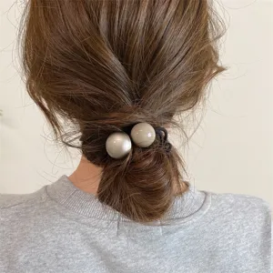 Minimalist retro double ball hair tie for low ponytail and bun styling detail view.