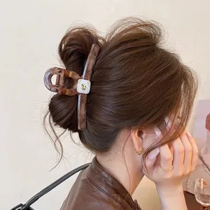 Large tortoiseshell hair claw clip with gold puppy detail, stylish hair accessory for women.