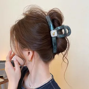 Large marble hair claw clip with gold puppy accent, stylish hair accessory for thick hair.