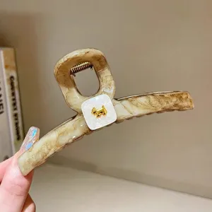 Acrylic hair claw clip with brown marble pattern and gold puppy charm for women daily wear