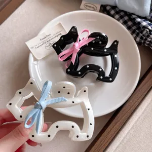 Cute puppy hair claw with bow and polka dots, stylish hairpin for women and girls daily wear.
