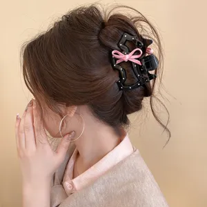 Cute black polka dot puppy hair claw clip with pink bow stylish hair accessories for women.