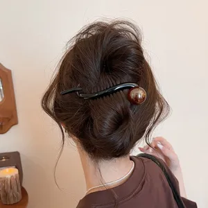 Stylish black and brown twist hair clip detail, elegant hairpin accessory for women daily updo.