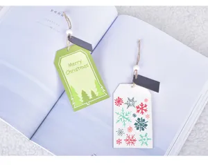 Detailed close-up of wooden Christmas tree hanging tags with festive patterns and rustic twine.