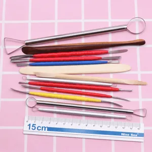 Stainless steel and wood clay sculpting tool set detail, precision modeling needles and blades.