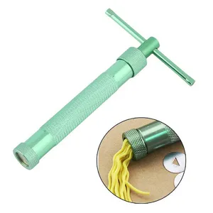 Rotary clay extruder detail showing metal die disks and yellow polymer clay extrusion process.
