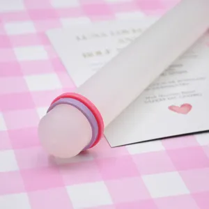 Detail shot of clear clay rolling pin with colorful rings for polymer clay and craft projects.