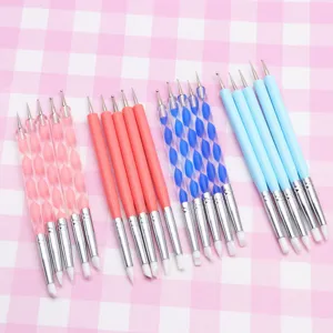 Close-up detail view of dual-ended silicone nail art pens and polymer clay carving tools.