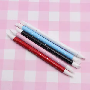 Silicone carving pen detail showing dual soft tips and colorful handles for clay crafts.