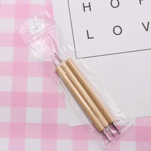 Close-up detail of three wooden handle ball stylus dotting tools in clear plastic packaging.