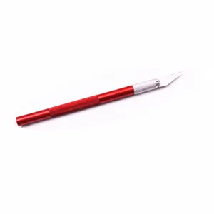 Red metal craft knife detail showing the 30-degree bevel blade and ergonomic handle for DIY.