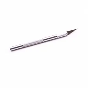 Close-up detail of metal craft hobby knife with textured handle and sharp blade.