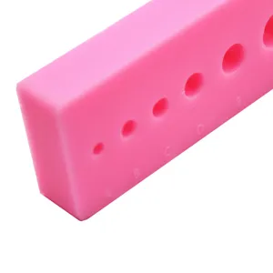 Detailed view of the pink silicone clay color mixing card with hole scales for polymer crafting.