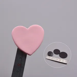 Soft clay heart DIY craft piece and adhesive magnetic sheet for fridge magnets sizing display.