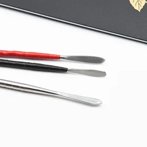 Close-up detail of stainless steel carving knife and polymer clay sculpting tools.