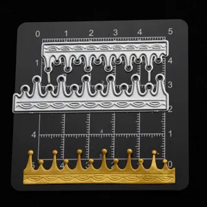 Detailed shot of crown metal cutting dies on measuring grid for DIY craft and clay projects.