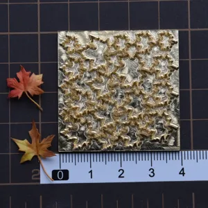 Detailed view of the finely carved brass mold featuring intricate floral texture for DIY clay crafts.