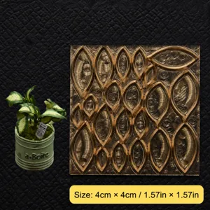 Closeup of miniature brass cutting die with leaf pattern for resin clay and craft embossing.