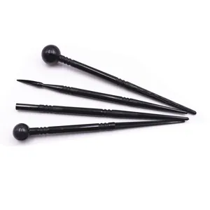 Detailed view of black plastic clay sculpting tool set, showing fine tips and ball ends.