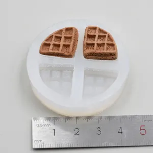 Miniature waffle silicone mold detail showing texture and size with metal ruler scale.