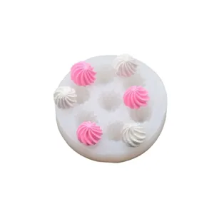 Close-up detail of the spiral cream silicone mold showing texture and finished clay pieces.