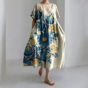 Detail view of the loose short-sleeve linen dress featuring large blue and yellow floral prints.