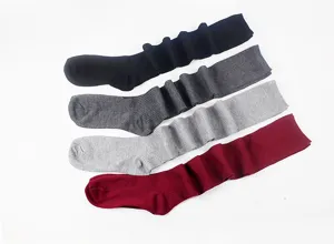 Close-up detail of women knit over-the-knee slouch socks in multi colors. Ribbed texture.