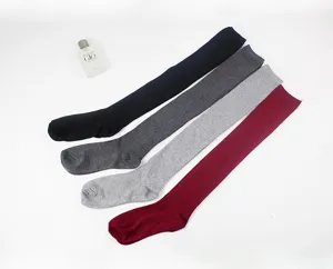 Detail shot of ribbed knit over-the-knee long socks in assorted colors, cozy winter style.