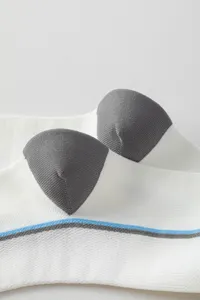 Close-up detail of white athletic compression socks with grey toe and blue stripe design.