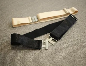 Detail shot of adjustable elastic boot straps and thigh garters in black and beige.