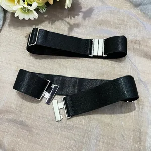 Detail view of adjustable black elastic anti-slip thigh bands with silver metal buckles for boots.