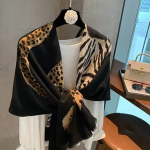 Detailed view of a chic black leopard and zebra print shawl scarf, vintage luxury style.