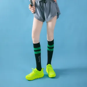 Detailed view of knee-high compression sports socks featuring striped design for leg support.