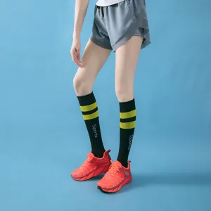 Close-up detail of women's sports compression long socks with striped pattern for fitness running.