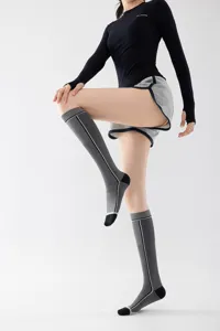 Detail view of professional compression calf socks featuring athletic stripes and fitted design.