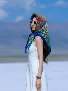 Exquisite retro printed silk square scarf detail, elegant outdoor scene showcasing fabric.