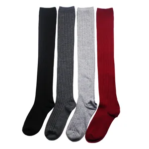 Close-up detail of knitted over-the-knee vertical striped long socks in multi colors.