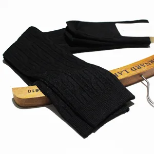 Detailed view of black cable knit over knee socks showing fine texture and soft cotton material.