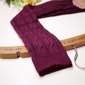 Detailed view of women's cable knit over knee socks in burgundy winter thermal hosiery.