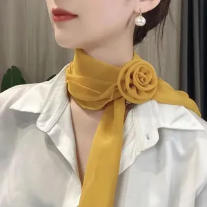 Close-up detail shot of elegant yellow chiffon rose neck scarf, soft floral necktie.