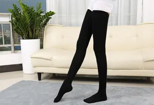 Close-up detail of black over-the-knee high socks, showing texture, soft fabric and fit.