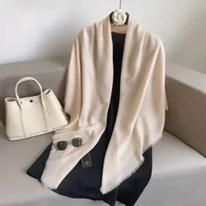 Detailed view of a solid beige large square scarf and shawl, elegant and versatile.