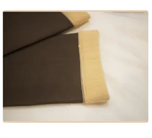 Detailed shot of fleece-lined over-the-knee leg warmers showing thick interior plush texture.